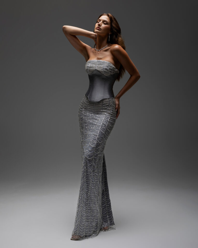 editorial side picture of dalila dress with metalic corset . fully embellished straight cut and strapless