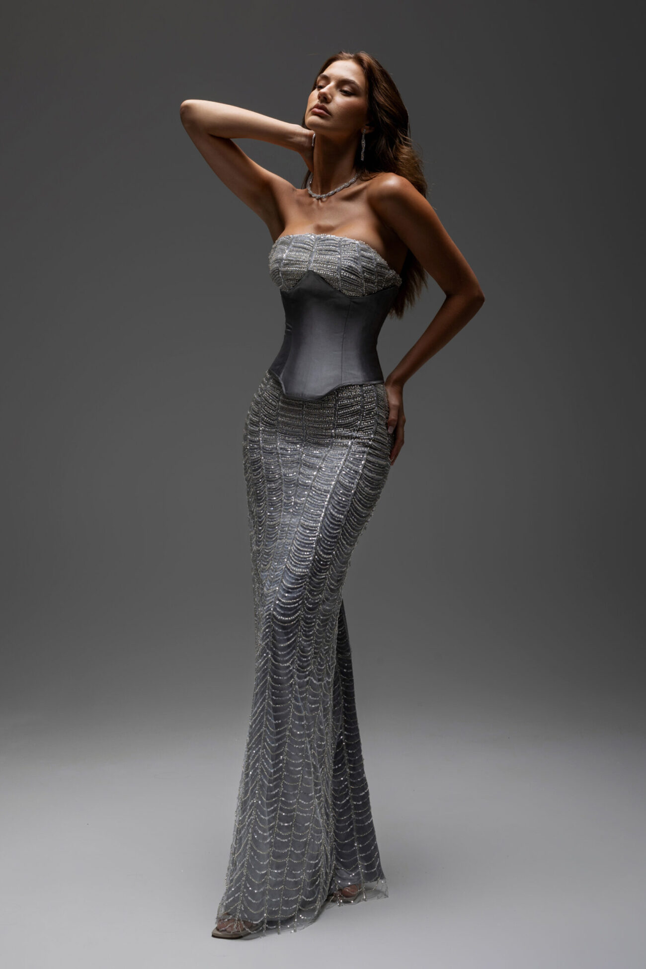 editorial side picture of dalila dress with metalic corset . fully embellished straight cut and strapless
