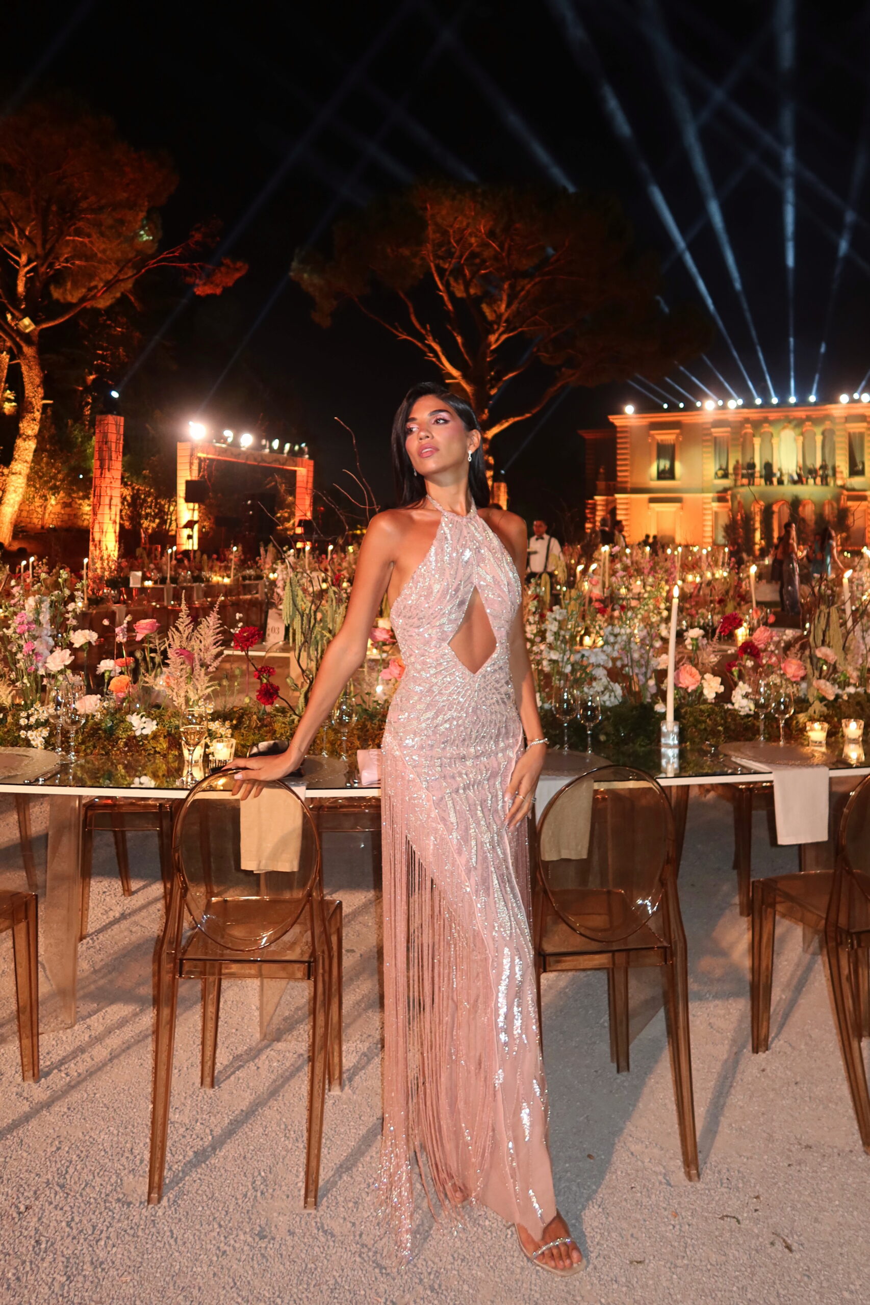 An editorial side picture of an oze by thd dress of Aurora haute couture gown in pink color